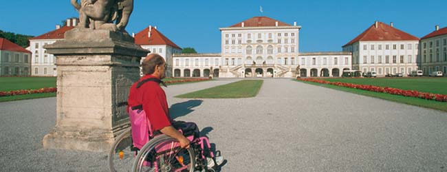 A wheelchair user in the parc of the castle Nymphenburg castle